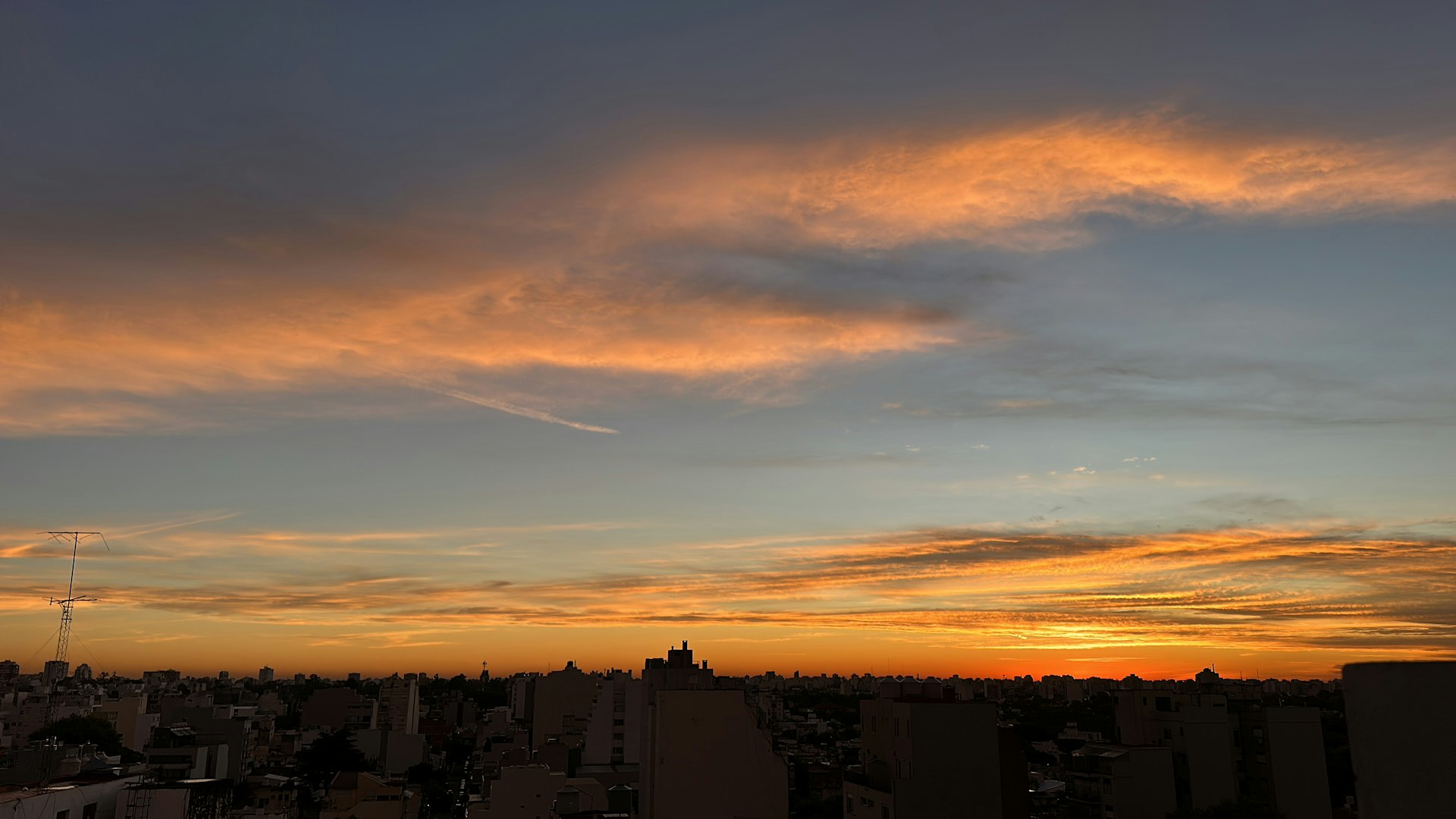 Aerial view of the Buenos Aires skyline at sunset with high-rise residential buildings.