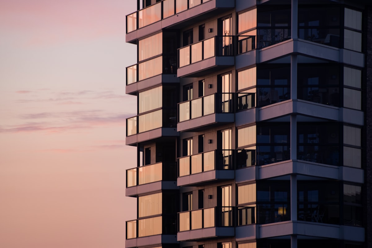 Modern residential tower with glazed balconies.